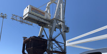 Crane lifting large equipment on a job-site