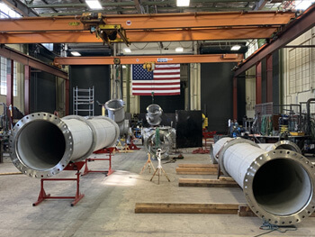 PMI fabrication facility with American flag on wall